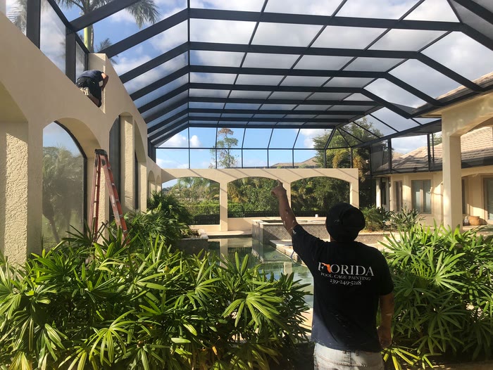 Looking along the columns and screen panels of a large enclosure toward the pool.