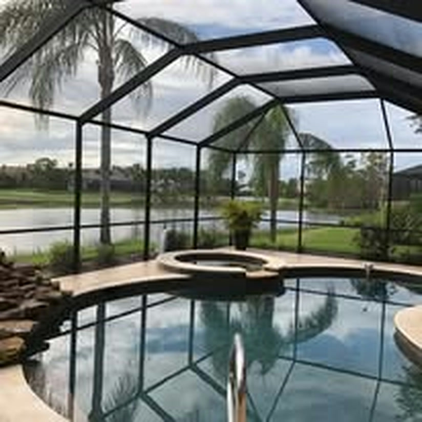 The same pool enclosure after painting, the frame a deep bronze against the lake.