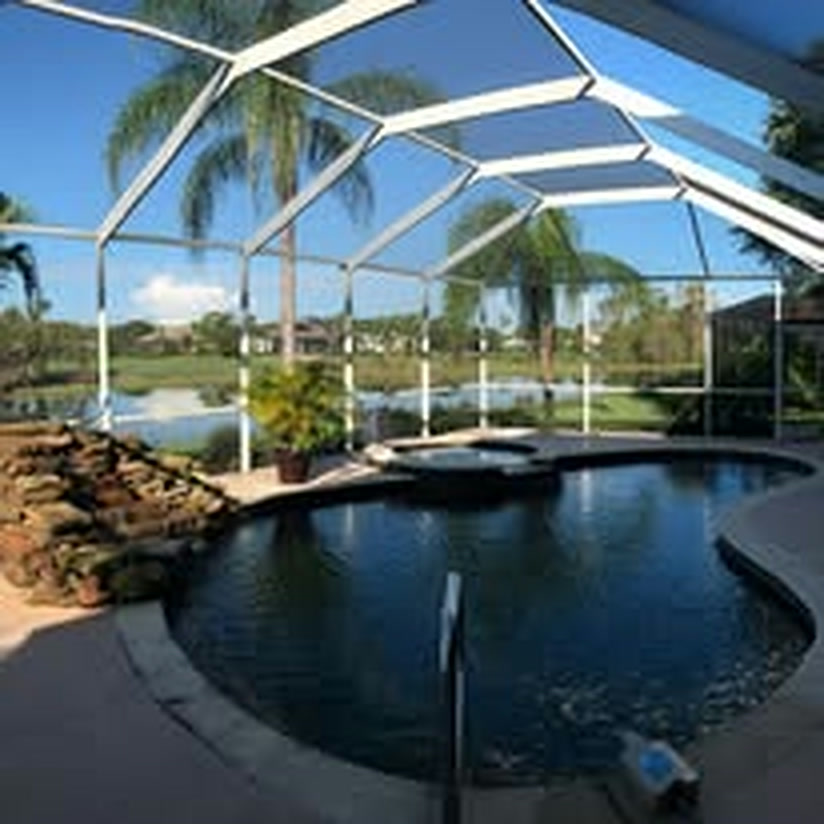The pool enclosure before painting, the frame white and weathered.